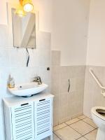 a bathroom with a sink and a toilet at Charmante maison familiale in Ouistreham