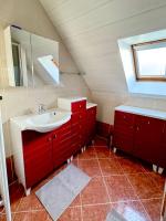 a bathroom with a red sink and a mirror at Charmante maison familiale in Ouistreham