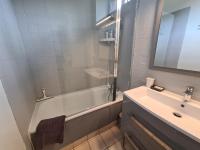 a bathroom with a tub and a sink and a mirror at Gîte Arthon, 5 pièces, 8 personnes - FR-1-591-372 in Arthon