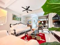 a living room with a white couch and chairs at AI Home 3 at Melaka City for Big Group in Melaka