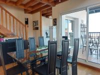 a dining room with a glass table and chairs at Appartement Urrugne, 3 pièces, 6 personnes - FR-1-239-772 in Urrugne