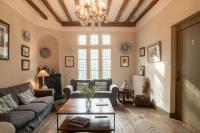 a living room with a couch and a table at HOTEL et APPARTEMENTS DOMAINE DES CLOS - Teritoria in Beaucaire