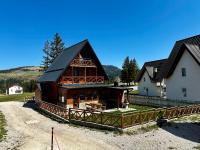 a large log cabin with a house at Vlasic Odmor - Villa Krajina I in Vlasic