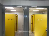 a row of yellow lockers in a bathroom at Nuit insolite dans un petit voilier in La Rochelle
