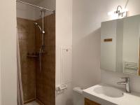 a white bathroom with a sink and a shower at Studio Les Menuires, 1 pièce, 2 personnes - FR-1-452-144 in Les Menuires