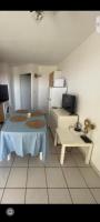 a small room with a bed and a table at Appartement residence le nautile in Le Grau-du-Roi