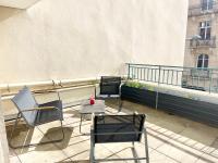 two chairs and a table on a balcony at Moderne T2 - Nancy gare (200m) - Wifi - Netflix in Nancy