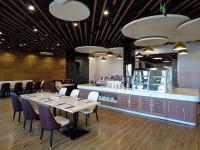 a dining room with tables and chairs and a counter at Escale International Hotel in Djibouti