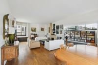 a living room with white furniture and bookshelves at Appartement atypique à Montsouris by Weekome in Paris