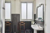 a bathroom with a sink and a mirror at Appartement atypique à Montsouris by Weekome in Paris