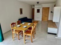 a dining table and chairs in a living room at Msida Central Suites in Msida