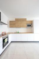 a kitchen with white cabinets and a sink at Msida Central Suites in Msida