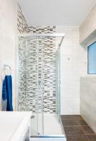 a bathroom with a shower with a glass door at Msida Central Suites in Msida