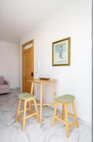 a table and two stools in a room at Msida Central Suites in Msida