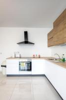 a white kitchen with a stove and a sink at Msida Central Suites in Msida