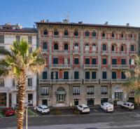 a large building with cars parked in front of it at Hotel Residence Esplanade in Viareggio