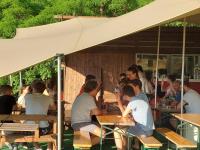 a group of people sitting at tables in a restaurant at Glamp-Inn Kapolcs in Kapolcs