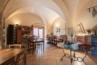 a large room with arches and tables and chairs at Agriturismo San Ottaviano in Monterotondo