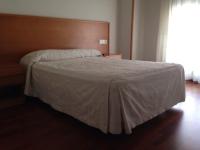 A bed or beds in a room at Hostal El Poligono