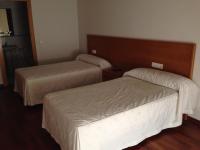 A bed or beds in a room at Hostal El Poligono