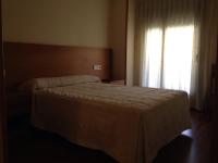 A bed or beds in a room at Hostal El Poligono
