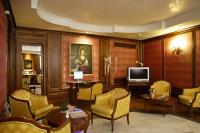 a living room with yellow chairs and a television at Hotel Kette in Venice