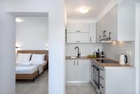 a kitchen with white cabinets and a bed at GIAMARIN in Istro