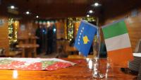 a table with two flags on top of a table at Madigan's Hotel in Kosovo Polje
