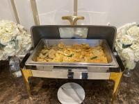 a pan of food on a table with flowers at شقق قصر ارين in Jeddah