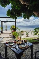 Una mesa de picnic con comida en la playa. en South Pacific Memories, en Port Vila