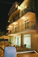 a building with a balcony with a table and chairs at Hotel Diva in Ravda