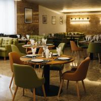 a dining room with tables and chairs and a restaurant at Хижа Марциганица in Asenovgrad