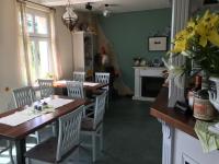 a kitchen with a table and chairs and a dining room at Ferienhof Altglobsow/ Cafe Seeblick in Großwoltersdorf