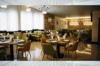 a restaurant with tables and chairs in a room at Хижа Марциганица in Asenovgrad