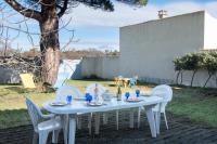 a white table with white chairs and a white table and chairsearcher at La villa Laurette - Maison de vacances familiale in Île dʼAix