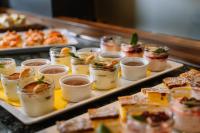 a buffet with many different types of food on trays at Hotel Auszeit St Lambrecht in Sankt Lambrecht
