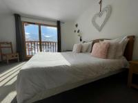 a bedroom with a bed with a heart on the wall at Le Vancouver in La Plagne