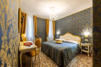 a hotel room with a bed and a table and a desk at Hotel Il Mercante di Venezia in Venice