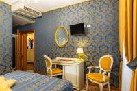 a bedroom with a bed and a desk and a mirror at Hotel Il Mercante di Venezia in Venice