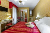 a hotel room with two beds and a bathroom at Hotel Il Mercante di Venezia in Venice