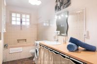 a bathroom with a sink and a toilet and a mirror at La villa Laurette - Maison de vacances familiale in Île dʼAix