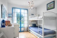 a bedroom with two bunk beds and a desk at La villa Laurette - Maison de vacances familiale in Île dʼAix