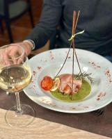 a plate of food on a table with a glass of wine at B&B Del Centro e SPA in Partinico