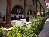 a row of plants in stone planters outside of a building at STUDIO DELUXE IN MARINA CAPE 4 stars complex 33 7 in Aheloy