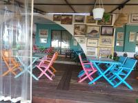 a room with colorful chairs and tables in a restaurant at STUDIO DELUXE IN MARINA CAPE 4 stars complex 33 7 in Aheloy