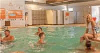 a group of people in a swimming pool at Bungalow pour 5 - TV - Clim - Terrasse ensoleillée in Boofzheim