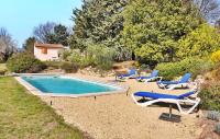 a pool with chaise lounge chairs and a swimming pool at Le Gite Du Bastidon in La Tour-dʼAigues