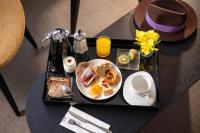 a tray with a plate of breakfast food on a table at Hotel D - Strasbourg in Strasbourg