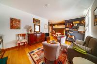 a living room with a couch and chairs at Delma&#39;s home in San Daniele del Friuli