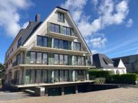 an apartment building with a gambrel roof at My Fair - Koksijde in Koksijde